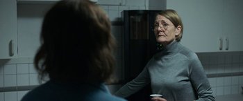 Movie still from “Border” (2018), directed by Ali Abbasi – An older woman is looking in the mirror; Medium shot, Over the shoulder angle
