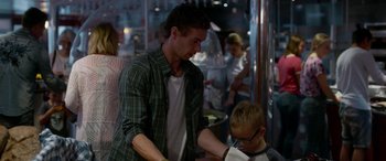 Movie still from “Border” (2018), directed by Ali Abbasi – A man and a boy are standing in a room; Medium shot, Over the shoulder angle