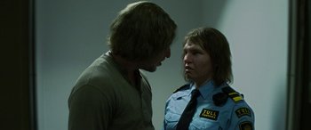 Movie still from “Border” (2018), directed by Ali Abbasi – A man and a woman are talking to each other; Medium shot, Over the shoulder angle