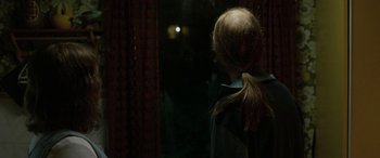 Movie still from “Border” (2018), directed by Ali Abbasi – A girl with a ponytail looking out of a window; Close Up shot, Over the shoulder angle
