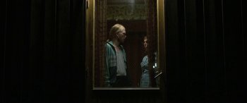 Movie still from “Border” (2018), directed by Ali Abbasi – A man and a woman looking at each other in a mirror; Medium shot, Low angle