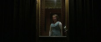 Movie still from “Border” (2018), directed by Ali Abbasi – A woman standing in front of a bathroom mirror; Medium shot, Low angle