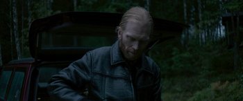 Movie still from “Border” (2018), directed by Ali Abbasi – A person wearing a leather jacket; Close Up shot, Over the shoulder angle