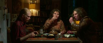 Movie still from “Border” (2018), directed by Ali Abbasi – A group of people sitting around a table eating; Medium shot, Over the shoulder angle