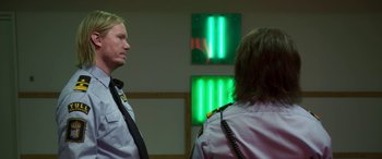 Movie still from “Border” (2018), directed by Ali Abbasi – A man and a woman standing next to each other in a room; Medium shot, Over the shoulder angle