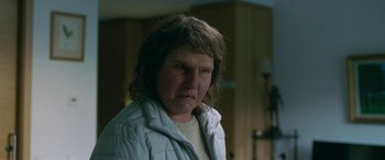 Movie still from “Border” (2018), directed by Ali Abbasi – A person wearing a white jacket; Close Up shot, Low angle