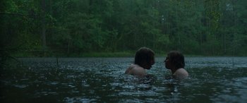 Movie still from “Border” (2018), directed by Ali Abbasi – Two people are swimming in a body of water; Medium shot, Over the shoulder angle
