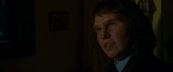 Movie still from “Border” (2018), directed by Ali Abbasi – A man in a suit and tie looking at the camera; Close Up shot, Over the shoulder angle