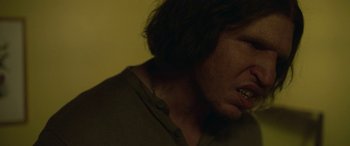 Movie still from “Border” (2018), directed by Ali Abbasi – A person's face with a beard; Close Up shot, Over the shoulder angle