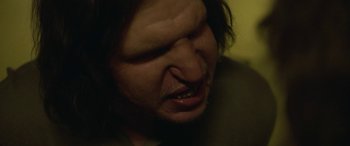 Movie still from “Border” (2018), directed by Ali Abbasi – A man with long hair; Extreme Close Up shot, Low angle