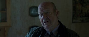 Movie still from “Border” (2018), directed by Ali Abbasi – An older man with a beard and a mustache; Close Up shot, Over the shoulder angle