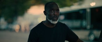 A man with a beard is looking into the distance