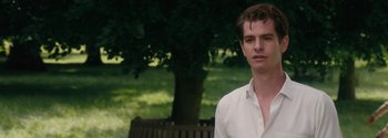 Movie still from “Breathe” (2017), directed by Andy Serkis – A man in a white shirt is standing by a bench; Close Up shot, Over the shoulder angle
