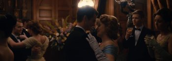 Movie still from “Breathe” (2017), directed by Andy Serkis – A man and a woman in formal wear dancing together; Medium shot, Low angle