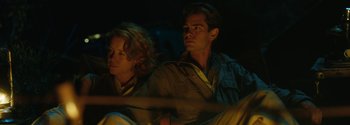 Movie still from “Breathe” (2017), directed by Andy Serkis – A man and a woman sitting next to each other in the dark; Medium shot, Low angle