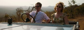 Movie still from “Breathe” (2017), directed by Andy Serkis – A man and a woman driving a car; Medium shot, Low angle