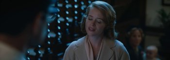Movie still from “Breathe” (2017), directed by Andy Serkis – A woman with her eyes closed in front of a bunch of bottles; Close Up shot, Over the shoulder angle
