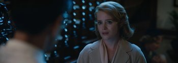 Movie still from “Breathe” (2017), directed by Andy Serkis – A woman with blonde hair and blue eyes looking at the camera; Close Up shot, Over the shoulder angle