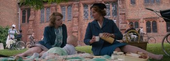 Movie still from “Breathe” (2017), directed by Andy Serkis – Two women and a baby are sitting at a table; Medium shot, Over the shoulder angle