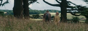 Movie still from “Breathe” (2017), directed by Andy Serkis – A man and a woman standing next to each other in a field; Wide shot, Low angle