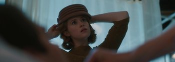 Movie still from “Breathe” (2017), directed by Andy Serkis – A woman in a brown sweater and a brown hat; Close Up shot, Low angle