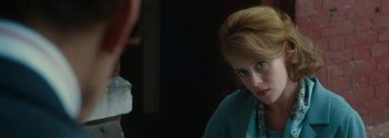 Movie still from “Breathe” (2017), directed by Andy Serkis – A woman with red hair is looking at the camera; Close Up shot, Over the shoulder angle