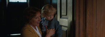 Movie still from “Breathe” (2017), directed by Andy Serkis – A woman holding a child in her arms; Close Up shot, High angle