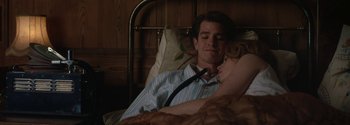 Movie still from “Breathe” (2017), directed by Andy Serkis – A man and a woman laying in a hospital bed; Medium shot, Low angle