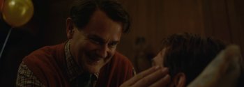 Movie still from “Breathe” (2017), directed by Andy Serkis – A person smiling at the camera; Close Up shot, Over the shoulder angle