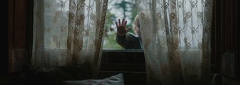 Movie still from “Breathe” (2017), directed by Andy Serkis – A little boy is looking out a window; Medium shot, High angle