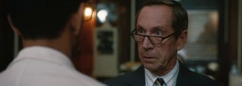 Movie still from “Breathe” (2017), directed by Andy Serkis – An older man in a suit and tie looking at another man in a suit and tie; Close Up shot, Over the shoulder angle