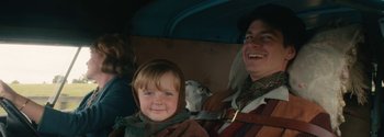 Movie still from “Breathe” (2017), directed by Andy Serkis – A young boy sitting next to an older man in a car; Close Up shot, Over the shoulder angle