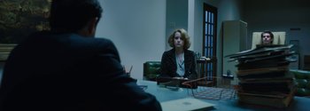 Movie still from “Breathe” (2017), directed by Andy Serkis – A woman sitting in front of a man at a table; Medium shot, Over the shoulder angle