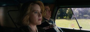 Movie still from “Breathe” (2017), directed by Andy Serkis – A man and a woman sitting in the back seat of a car; Close Up shot, Low angle
