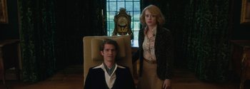 Movie still from “Breathe” (2017), directed by Andy Serkis – A man and a woman standing next to each other in a room; Medium shot, Low angle