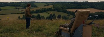 Movie still from “Breathe” (2017), directed by Andy Serkis – A woman standing on a hill looking out at the countryside; Extreme Wide shot, High angle