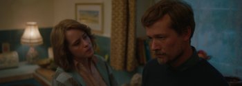 Movie still from “Breathe” (2017), directed by Andy Serkis – A man and a woman are sitting in a living room; Close Up shot, Over the shoulder angle
