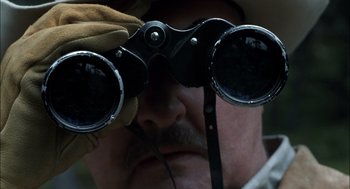 Movie still from “Brokeback Mountain” (2005), directed by Ang Lee – A person looking through binoculars; Extreme Close Up shot, Over the shoulder angle