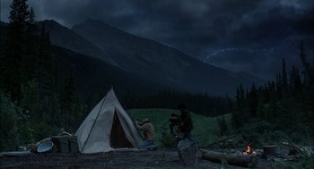 Movie still from “Brokeback Mountain” (2005), directed by Ang Lee – Two men setting up a tent in the dark; Wide shot, High angle