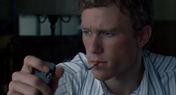 Movie still from “Brokeback Mountain” (2005), directed by Ang Lee – A man smoking a cigarette while holding a cell phone in his hand; Close Up shot, High angle
