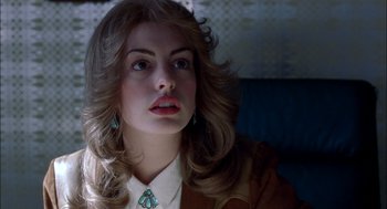 Movie still from “Brokeback Mountain” (2005), directed by Ang Lee – A woman with long blonde hair wearing a white shirt and a green necklace; Close Up shot, Over the shoulder angle