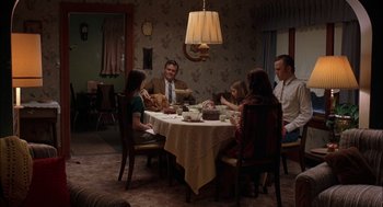 Movie still from “Brokeback Mountain” (2005), directed by Ang Lee – A group of people sitting around a table eating food; Wide shot, High angle