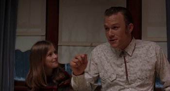 Movie still from “Brokeback Mountain” (2005), directed by Ang Lee – A man and a little girl sitting in front of each other; Medium shot, Over the shoulder angle