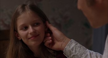 Movie still from “Brokeback Mountain” (2005), directed by Ang Lee – A person putting something in a girl's ear; Close Up shot, Over the shoulder angle