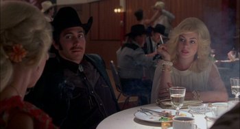 Movie still from “Brokeback Mountain” (2005), directed by Ang Lee – A man and a woman sitting at a dinner table; Medium shot, Over the shoulder angle