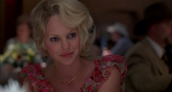 Movie still from “Brokeback Mountain” (2005), directed by Ang Lee – A woman with blonde hair wearing a pink and red floral dress; Close Up shot, Over the shoulder angle