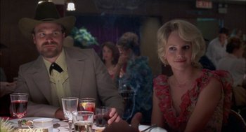 Movie still from “Brokeback Mountain” (2005), directed by Ang Lee – A man and a woman sitting at a dinner table; Medium shot, Over the shoulder angle