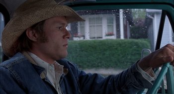 Movie still from “Brokeback Mountain” (2005), directed by Ang Lee – A man in a straw hat driving a car; Close Up shot, Low angle