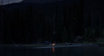 Movie still from “Brokeback Mountain” (2005), directed by Ang Lee – A tent is lit up on the shore of a lake; Extreme Wide shot, High angle