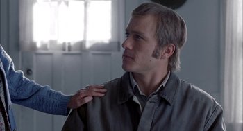 Movie still from “Brokeback Mountain” (2005), directed by Ang Lee – A person touching a man's shoulder in a room; Close Up shot, Over the shoulder angle